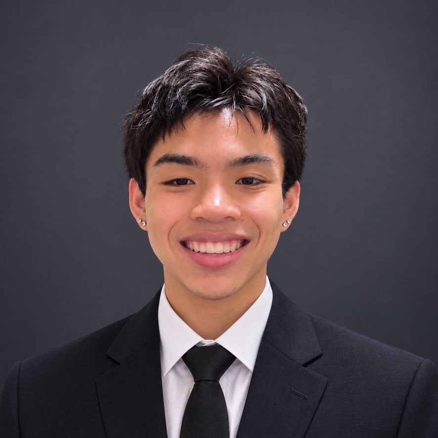 Huy Nguyen in a suit, smiling